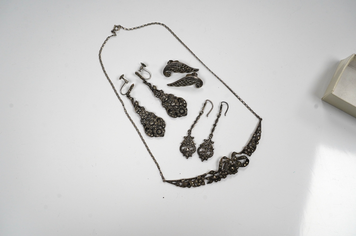 Two pairs of white metal and marcasite earrings, a similar pair of ear clips and a necklace. Condition - poor to fair